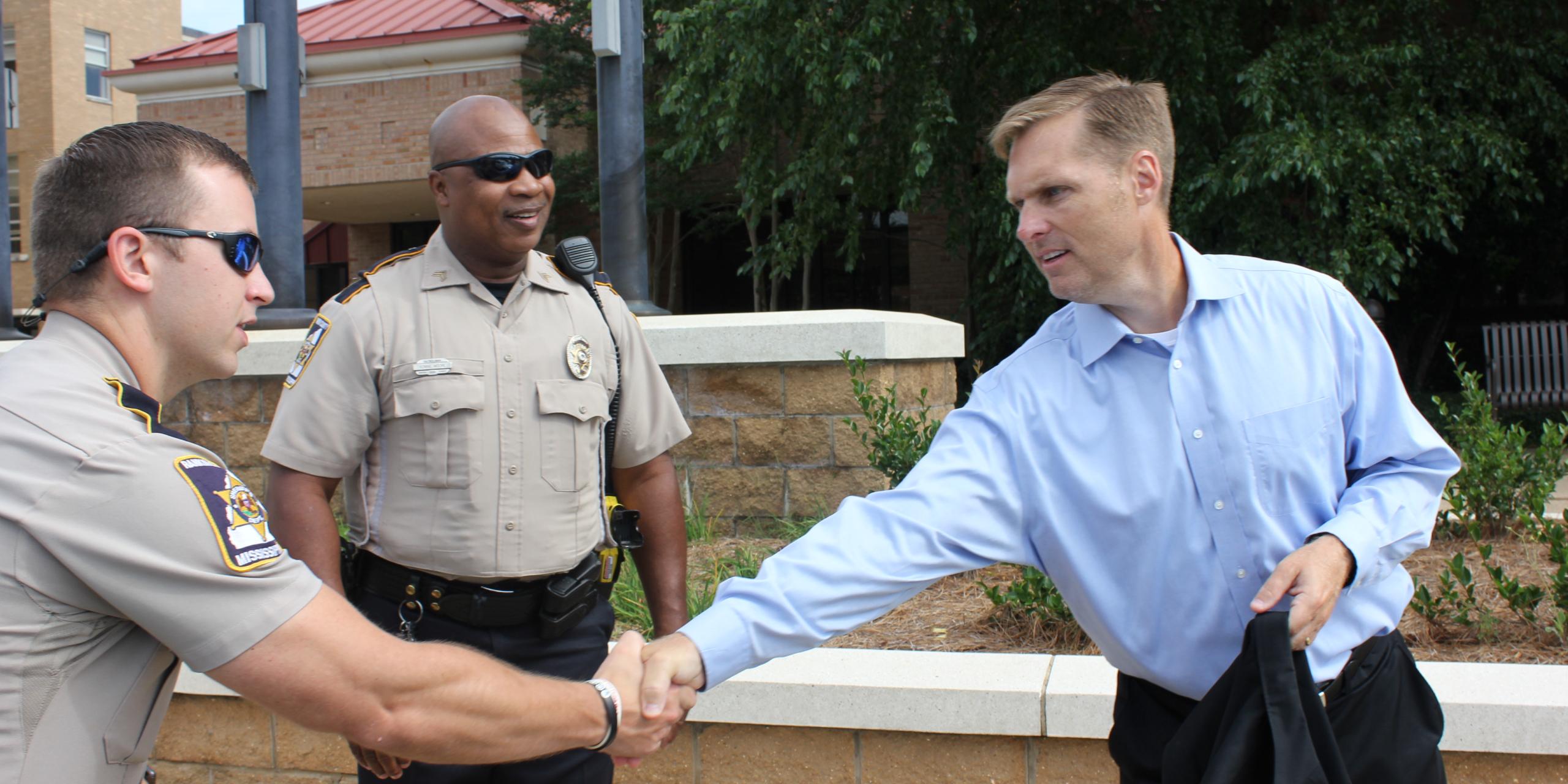 Congressman Guest Shaking Hands with Police Officers